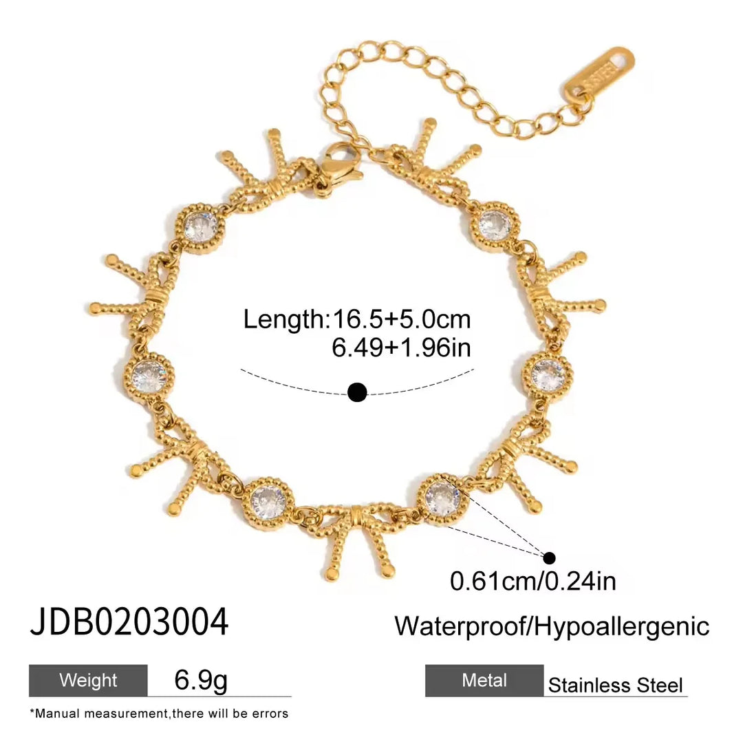 Gold-tone chain bracelet with sunburst and oval link details, shown on a white background with overlaid measurements, weight, and material information.