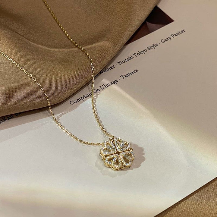 Gold necklace with a decorative pendant on a beige fabric background