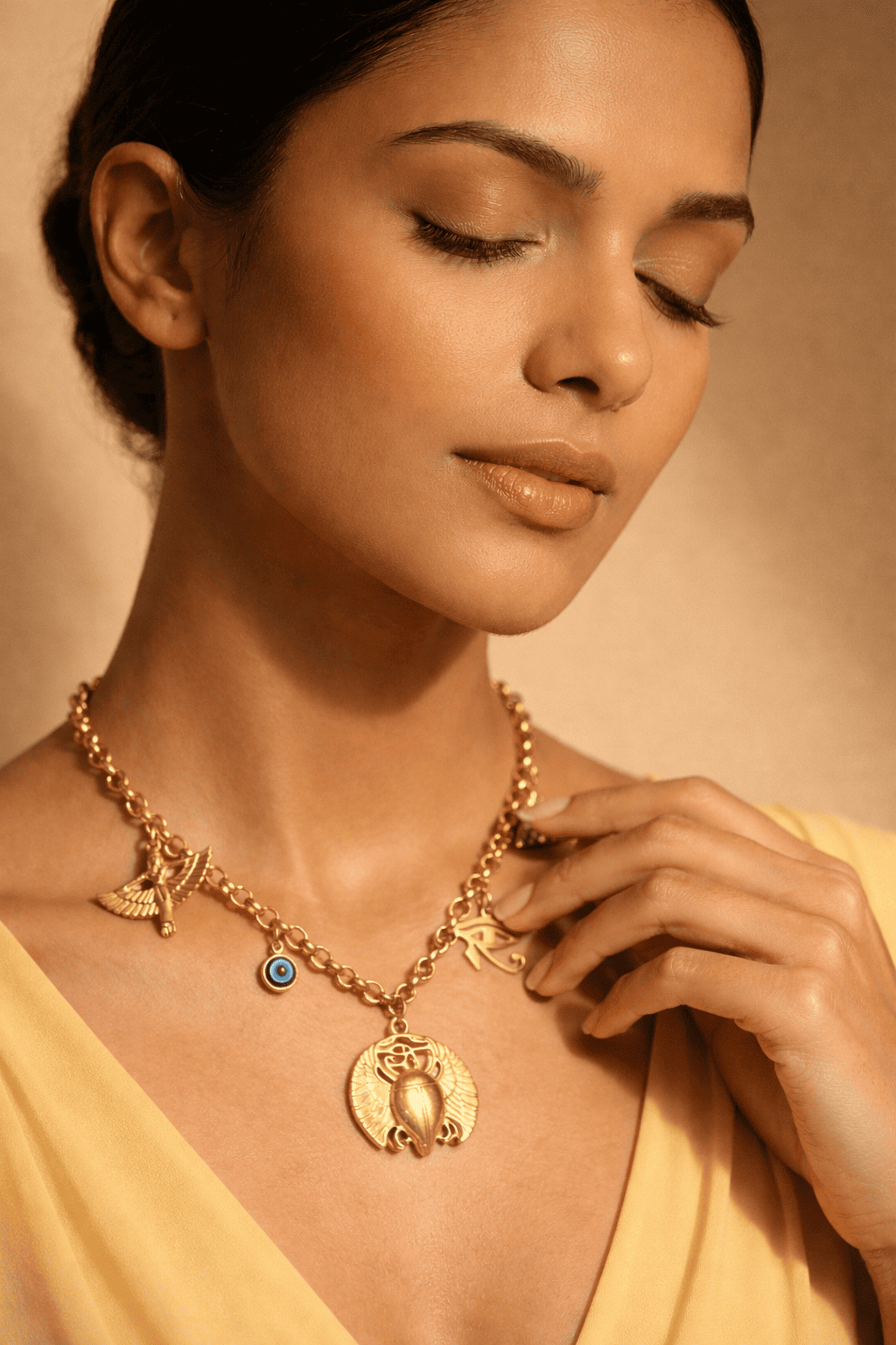 Woman wearing a gold necklace with a beige background