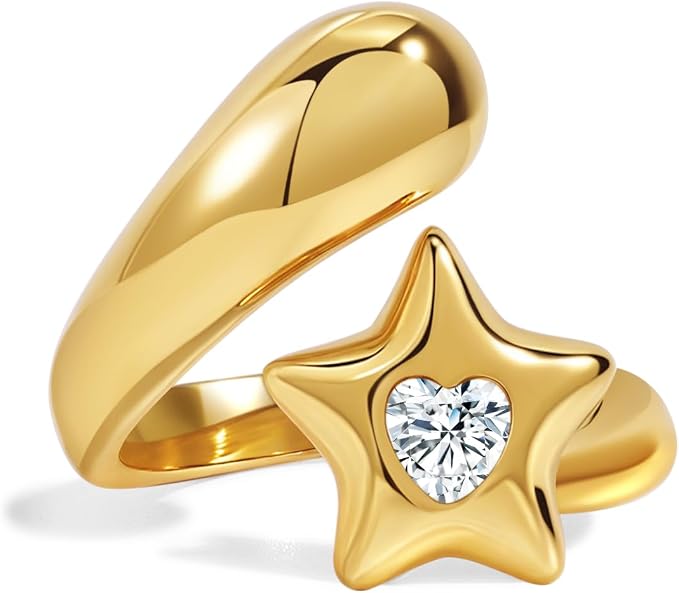 Gold ring with star-shaped design featuring a heart cutout and embedded gemstone on a white background