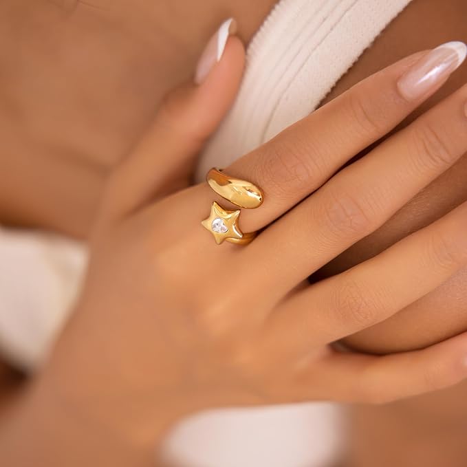 Gold ring with a star design on a person&