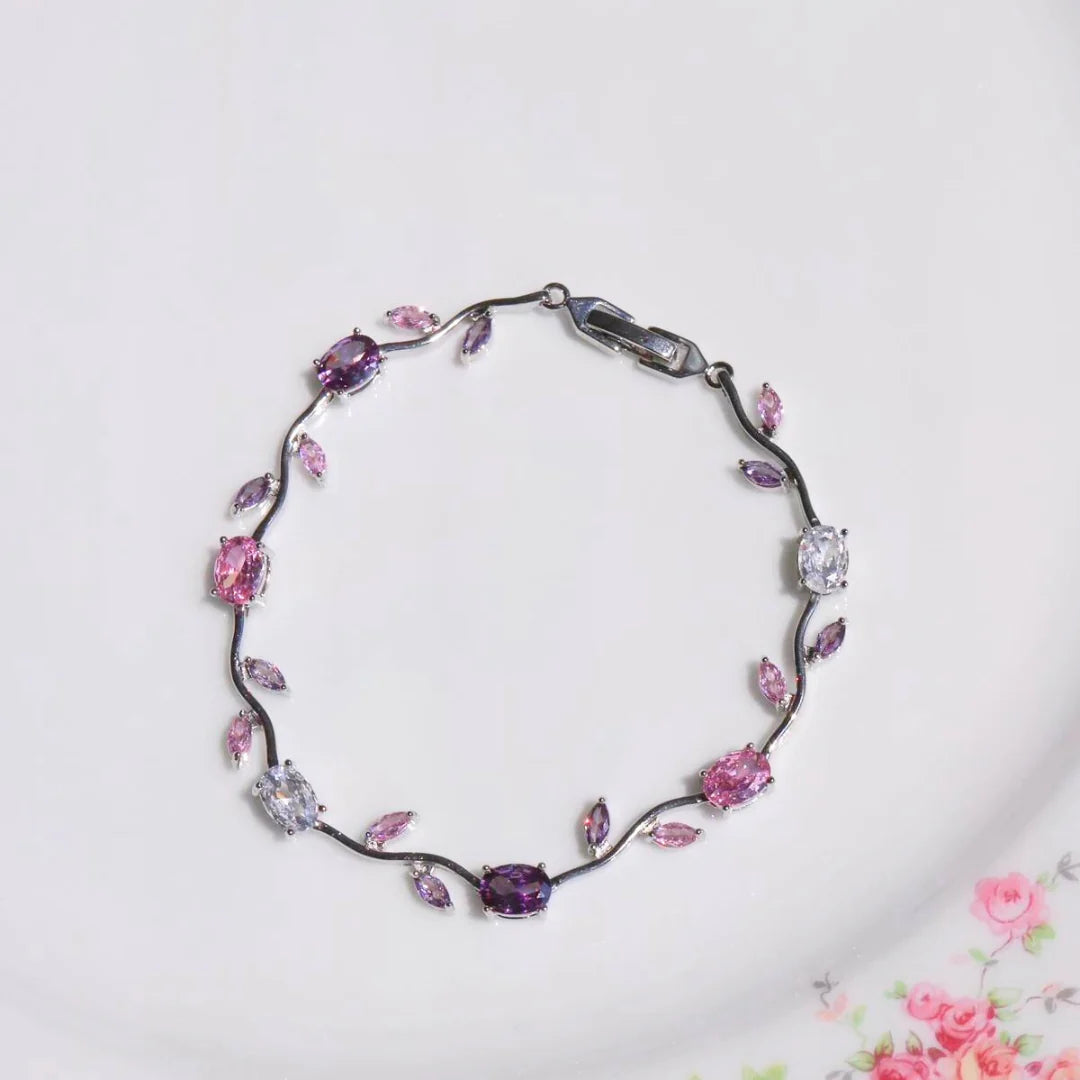 Bracelet with pink and purple gemstones on a white background