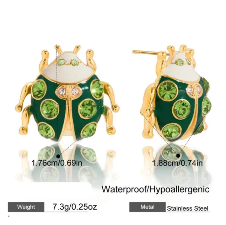 Two green ladybug-shaped stud earrings with gold-tone metal outlines and green rhinestones, shown front and back on a white background with size, weight, and &