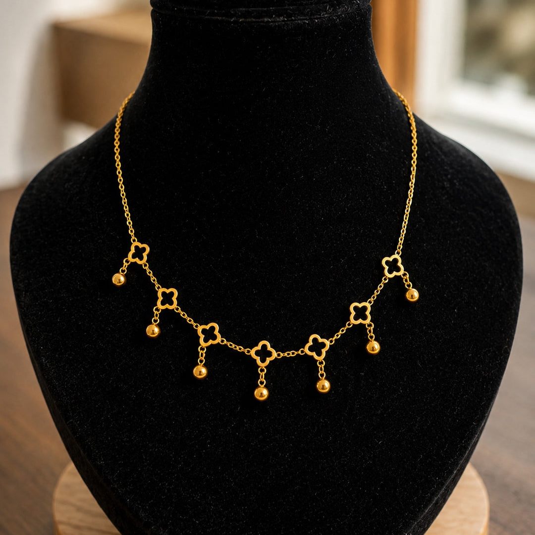 Gold necklace on a black velvet bust with a blurred background