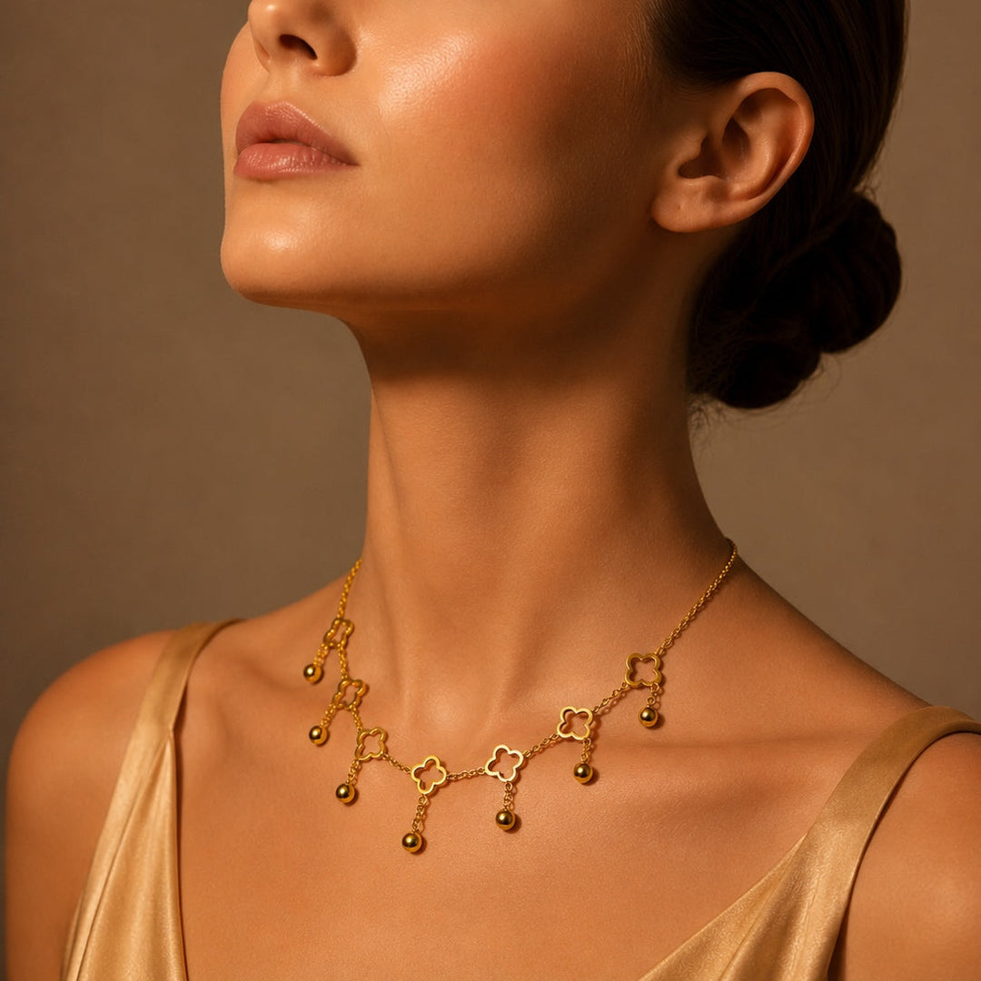 Woman wearing a gold necklace against a brown background