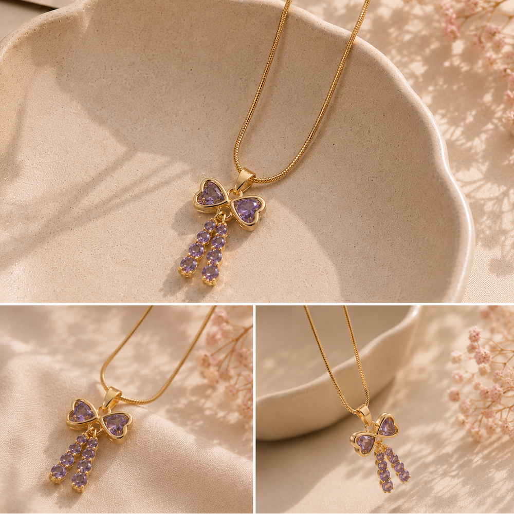 Gold necklace with a purple heart-shaped pendant on a soft background