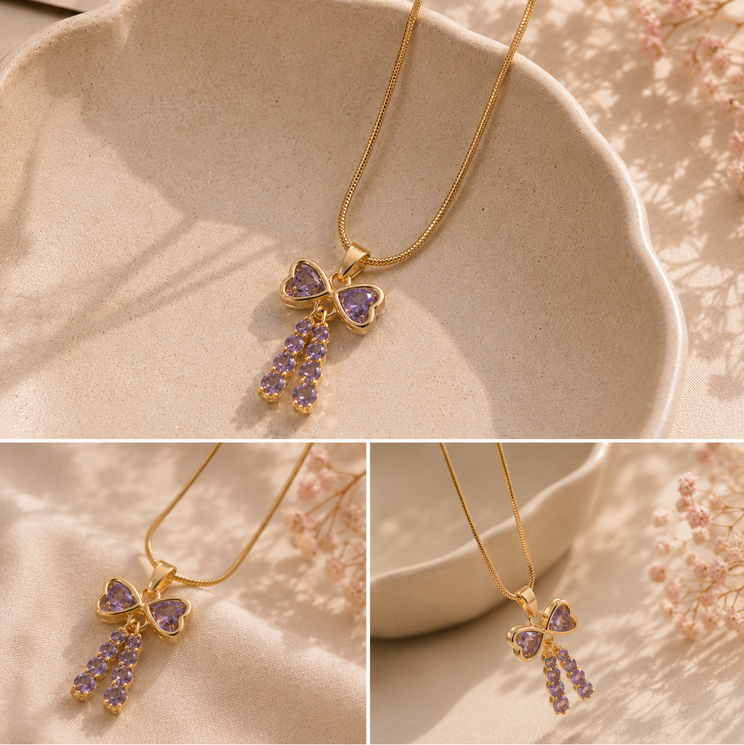 Gold necklace with a purple heart-shaped pendant on a soft background