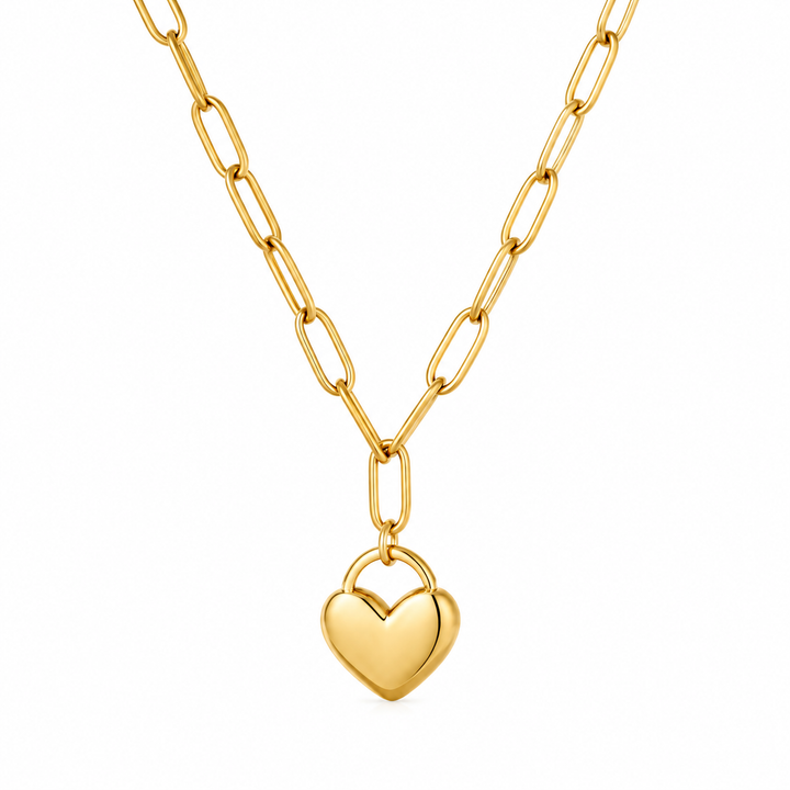 A gold paperclip chain necklace with a small, polished gold heart pendant, shown against a plain white background.