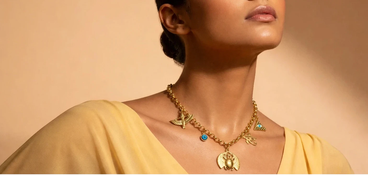 Woman wearing gold jewelry against a beige background
