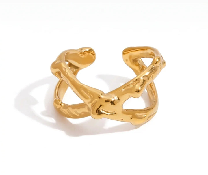 Gold ring with a unique design on a white background