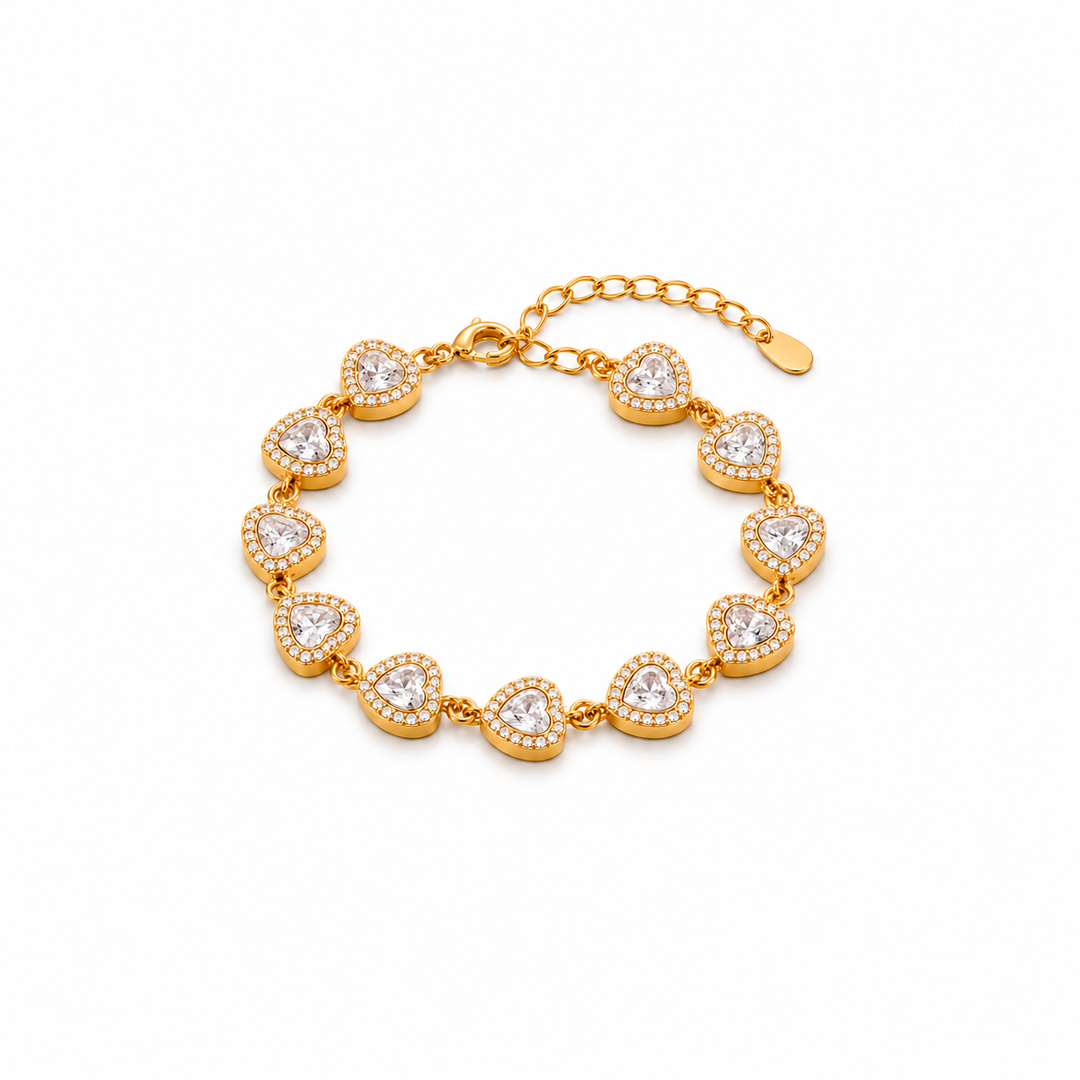 A gold bracelet featuring a series of heart-shaped pavé settings with clear round stones, connected by a delicate gold chain with an extender clasp, shown on a plain white background.