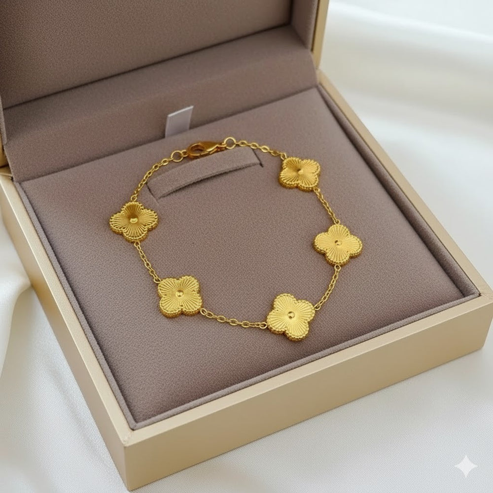 Gold bracelet with floral designs in a jewelry box