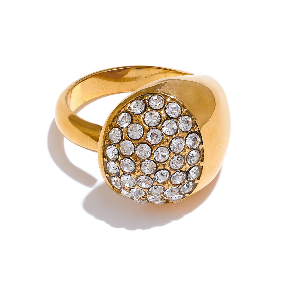 Gold ring with crystal embellishments on a white background