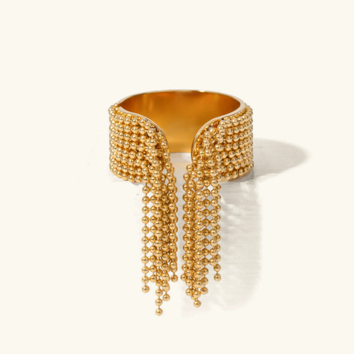 Gold beaded ring on a white background