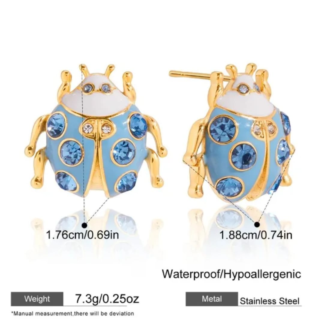 A pair of ladybug-shaped stud earrings shown from front and back views on a white background, with text indicating dimensions, weight, and stainless steel material.