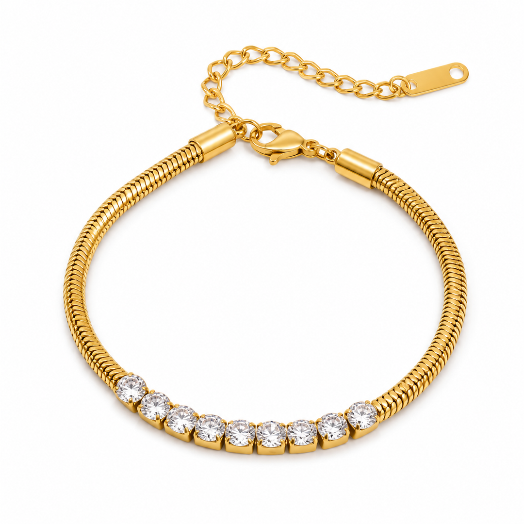 A gold snake-link bracelet with a row of clear round-cut stones along the front, displayed on a clean white background.