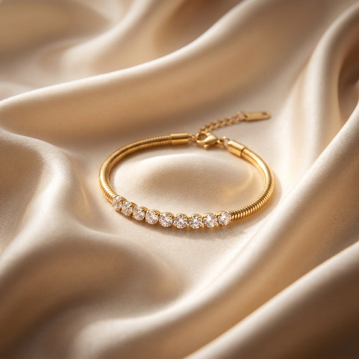 Gold bracelet with diamonds on a beige satin background