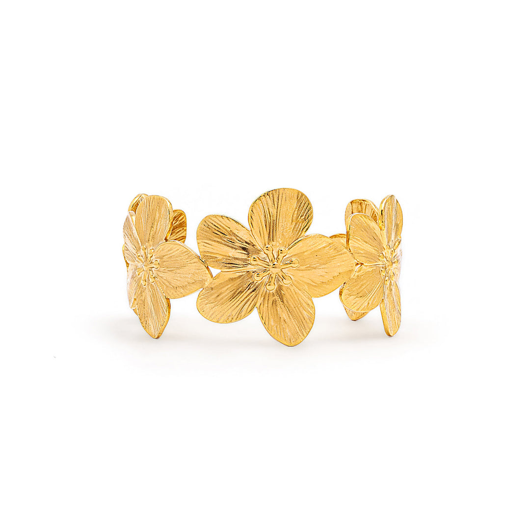 A gold-tone metal cuff ring featuring three textured, stylized flower petals arranged side-by-side, photographed on a clean white background.