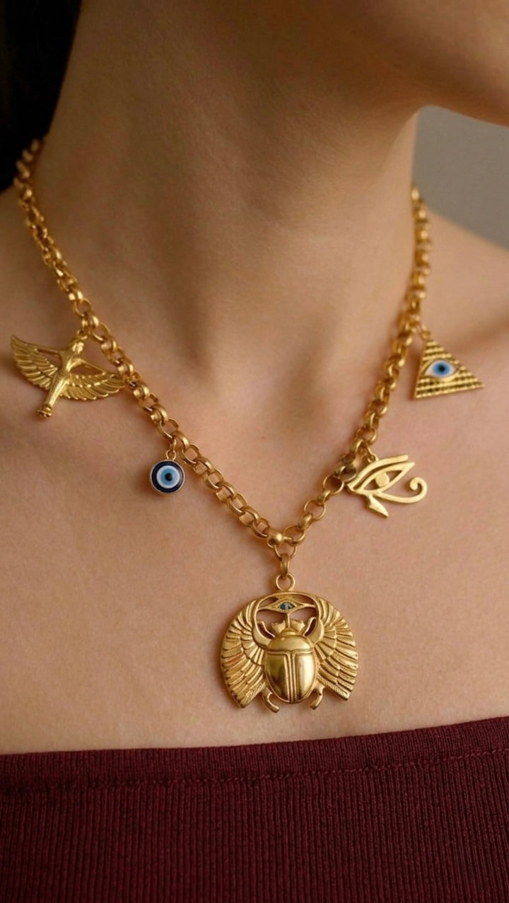 Gold necklace with various symbols on a person&