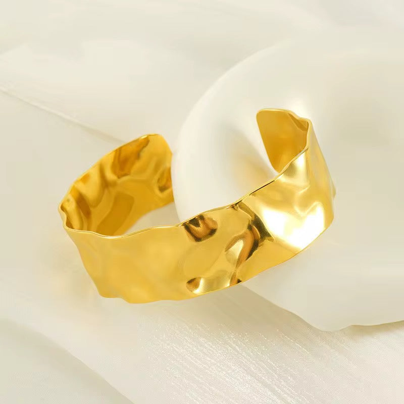 Gold bracelet on a white background
