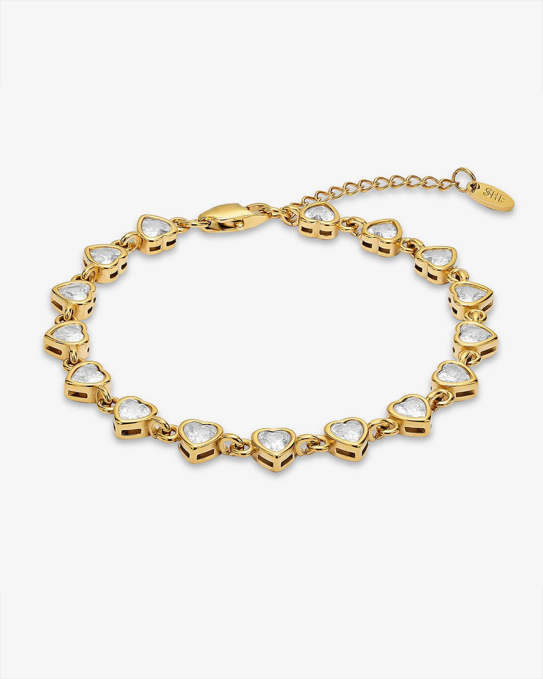A gold heart-link bracelet with clear heart-shaped stones, displayed on a light gray background.
