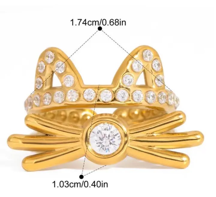Gold-tone cat-ear ring with clear rhinestones and a central round stone, shown on a white background with measurement lines and text indicating dimensions.