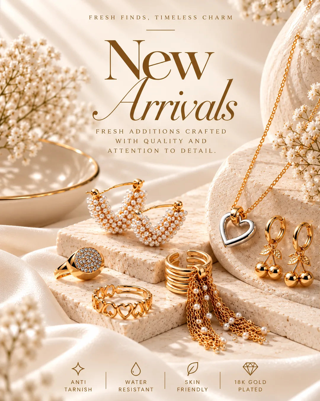 A styled jewelry display with gold-toned necklaces, earrings, rings, and pearl accents arranged on draped satin and stone blocks. Large text reads 'New Arrivals' with smaller marketing copy about fresh finds and quality detail.