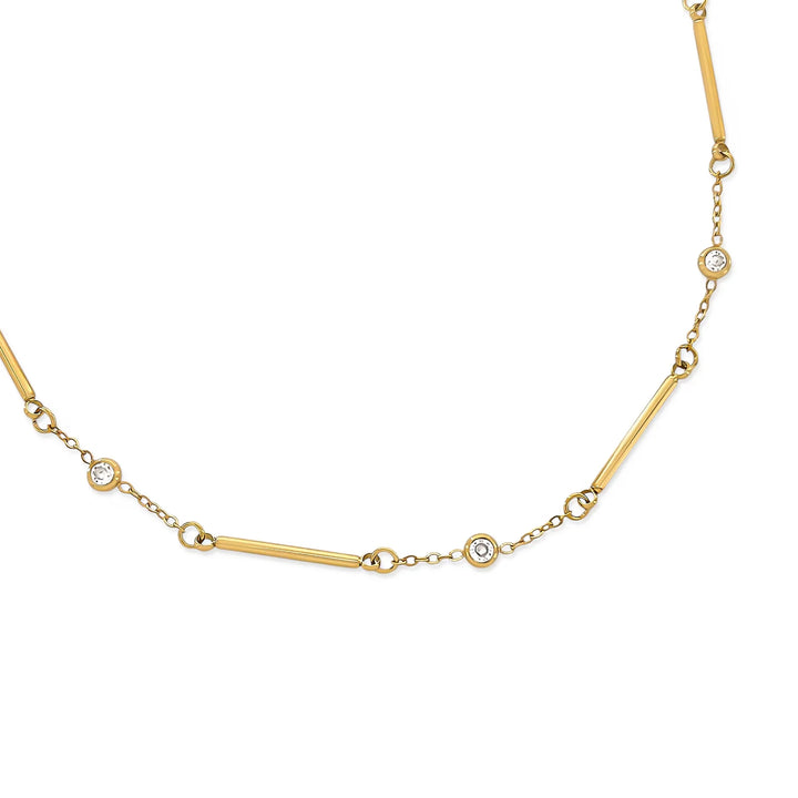 Gold necklace with small diamonds on a white background