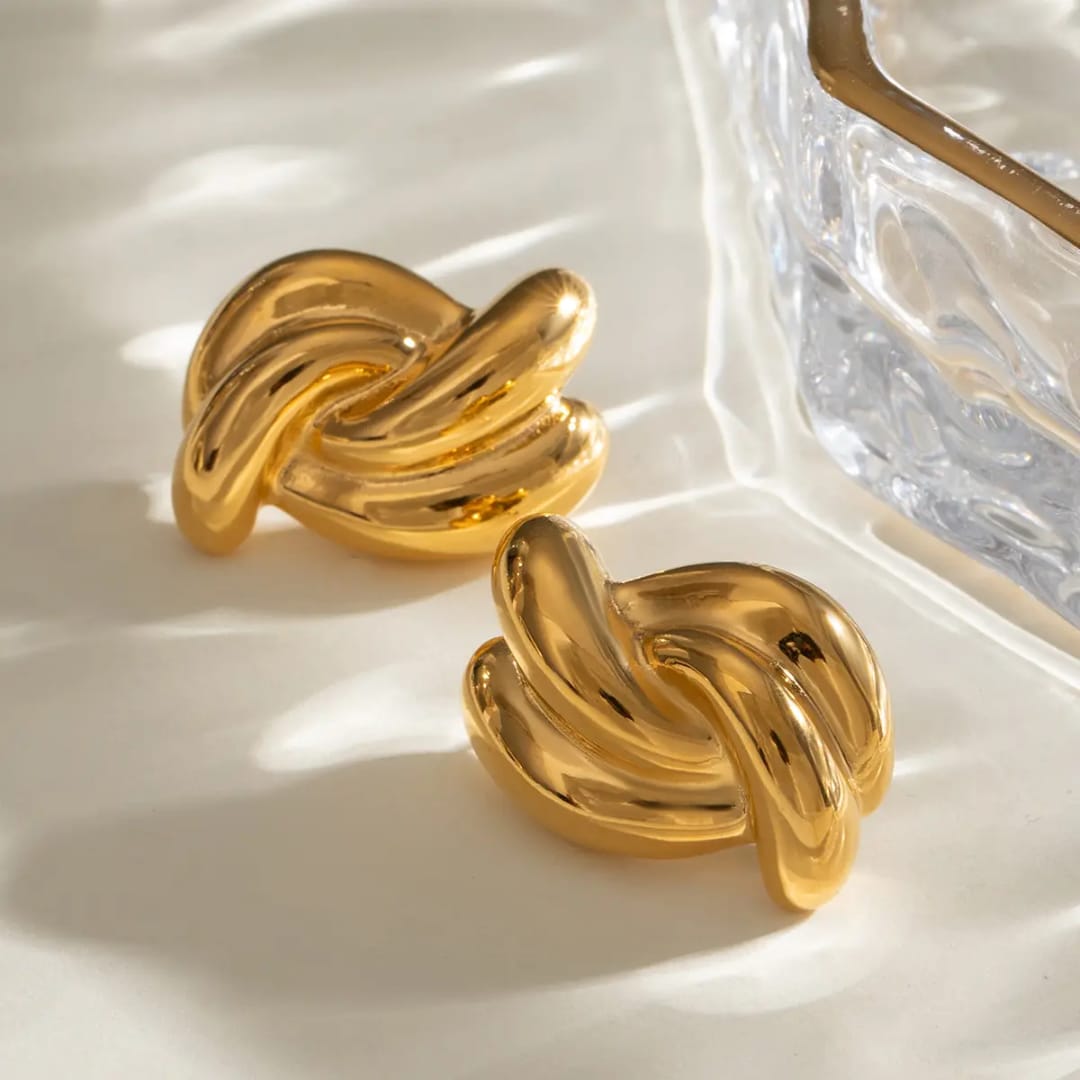 Pair of gold earrings on a light background