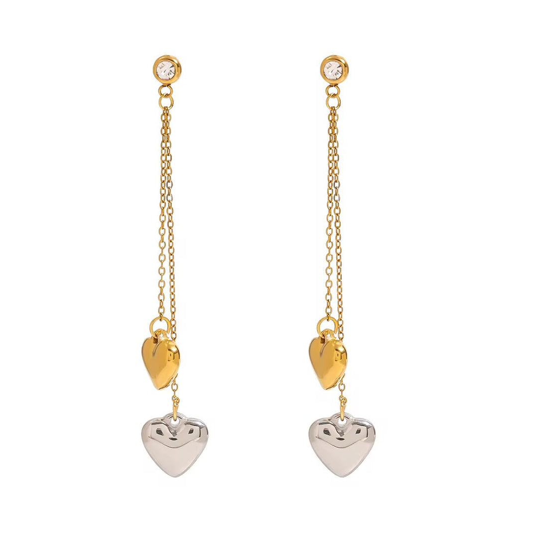 Gold and silver heart-shaped earrings on a white background
