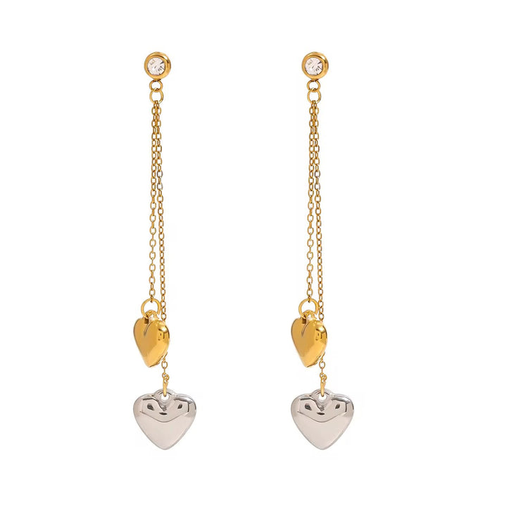 Gold and silver heart-shaped earrings on a white background