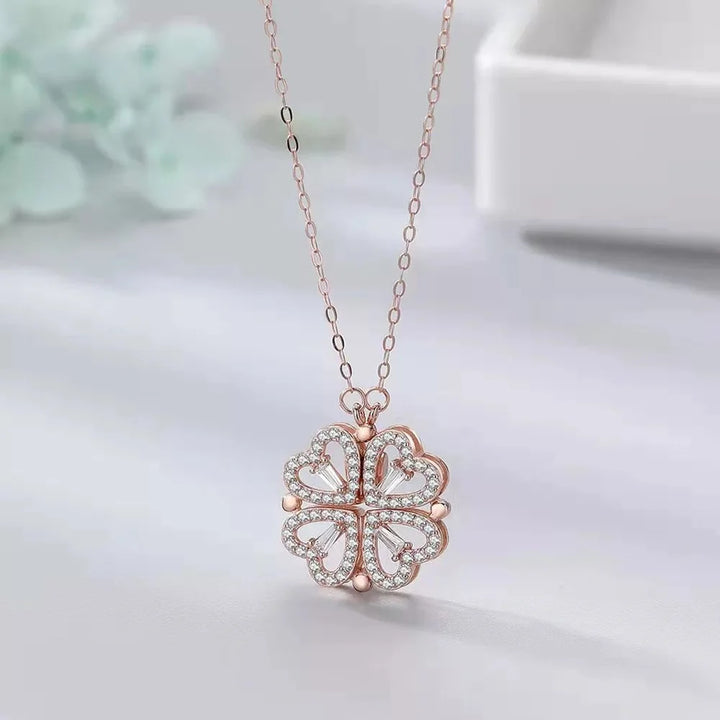 Rose gold necklace with a clover-shaped pendant on a light background