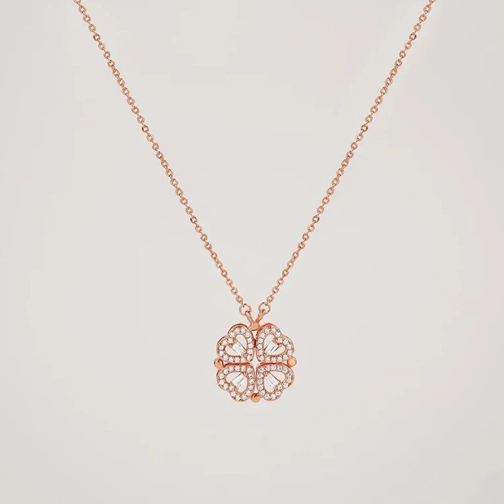 Rose gold necklace with a heart-shaped pendant on a light gray background